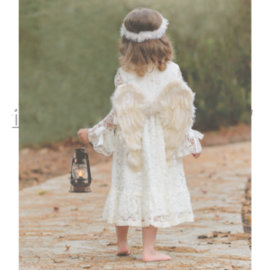 girl dressed as angel carrying lamp