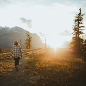 lady walking towards sunrise